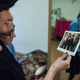 Shtern-Sara Cherkassky looking at a photograph of her husband Asher, taken before the war.